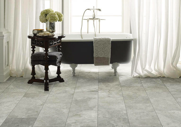 Bathroom with clawfoot tub on tile flooring | The L&L Company