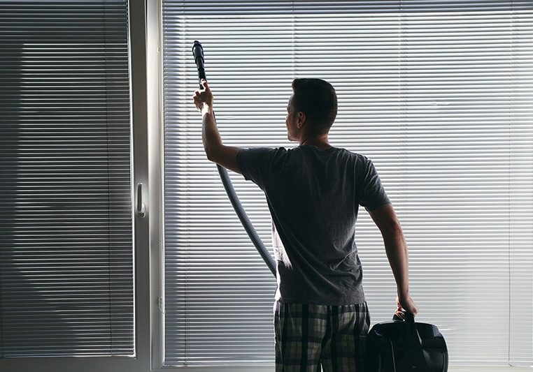 Man Preforming Routine Window Covering Care | The L&L Company